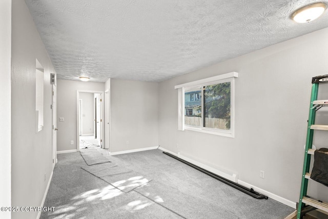 1100 Fred Cir, Anchorage, AK 99515 - unfurnished bedroom featuring a textured ceiling, baseboards, and carpet floors