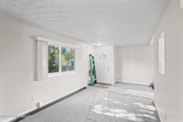 1100 Fred Cir, Anchorage, AK 99515 - foyer featuring carpet floors, baseboard heating, baseboards, and a textured ceiling
