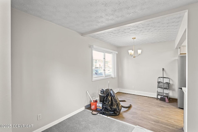 1100 Fred Cir, Anchorage, AK 99515 - exercise room with baseboards, a chandelier, a textured ceiling, and wood finished floors