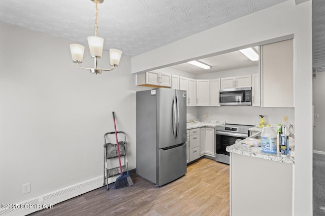 1100 Fred Cir, Anchorage, AK 99515 - kitchen with stainless steel appliances, light wood-type flooring, a chandelier, a textured ceiling, and light stone countertops