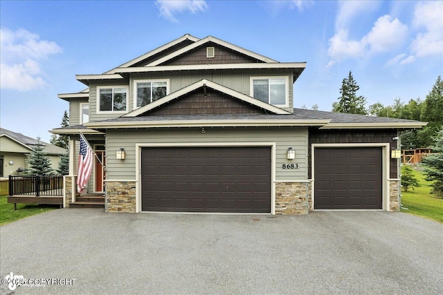 8683 Estates Cir, Anchorage, AK 99507 - craftsman inspired home featuring stone siding, driveway, and an attached garage