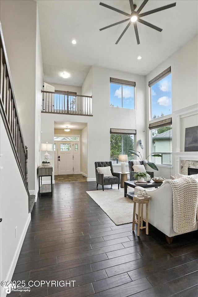 8683 Estates Cir, Anchorage, AK 99507 - living area with ceiling fan, a towering ceiling, hardwood / wood-style flooring, recessed lighting, and a fireplace