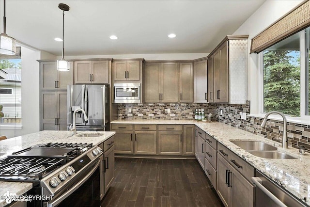 8683 Estates Cir, Anchorage, AK 99507 - kitchen featuring stainless steel appliances, dark wood-type flooring, healthy amount of natural light, light stone counters, and recessed lighting