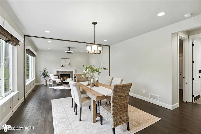 8683 Estates Cir, Anchorage, AK 99507 - dining space with wood finished floors, recessed lighting, and a lit fireplace
