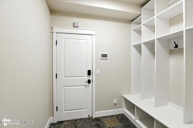 8683 Estates Cir, Anchorage, AK 99507 - mudroom featuring baseboards and stone finish floors