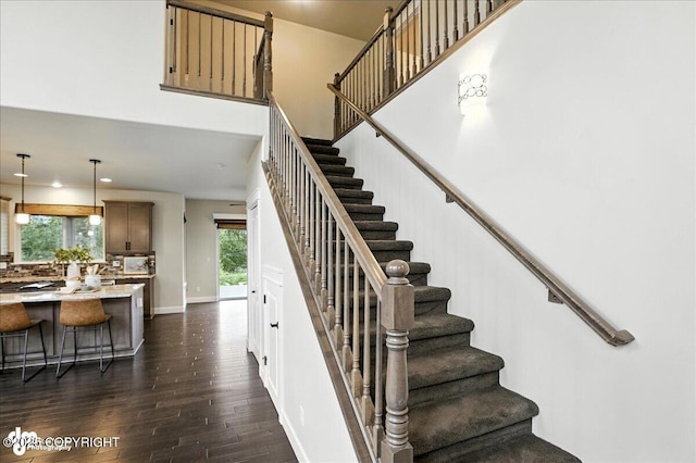 8683 Estates Cir, Anchorage, AK 99507 - stairway featuring wood finished floors, recessed lighting, and a high ceiling