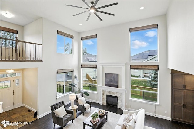 8683 Estates Cir, Anchorage, AK 99507 - living area with ceiling fan, a glass covered fireplace, healthy amount of natural light, and recessed lighting