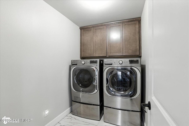 8683 Estates Cir, Anchorage, AK 99507 - laundry room featuring washer and dryer, cabinet space, and light marble finish floors