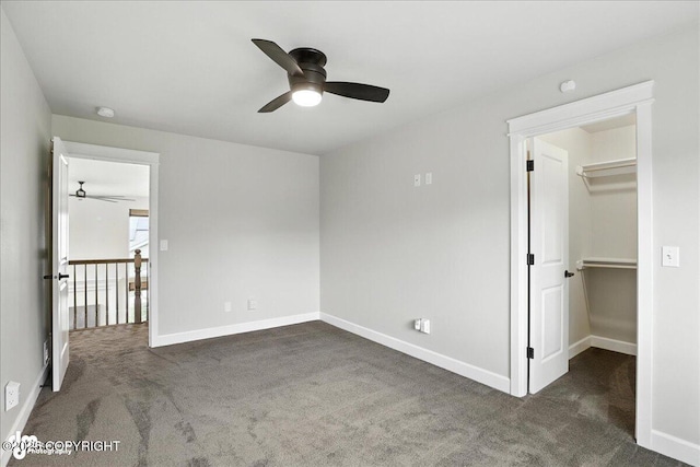 8683 Estates Cir, Anchorage, AK 99507 - unfurnished bedroom featuring carpet, a walk in closet, and a ceiling fan