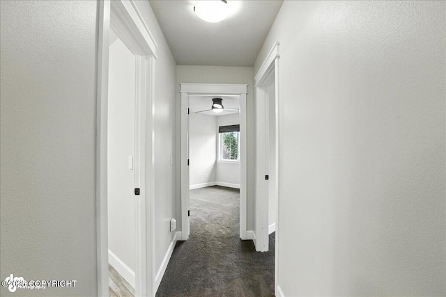 8683 Estates Cir, Anchorage, AK 99507 - hall featuring baseboards and dark colored carpet