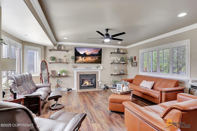 2548 S Gallop Cir, Wasilla, AK 99654 - living room featuring light wood-style flooring, ceiling fan, recessed lighting, a tile fireplace, and crown molding