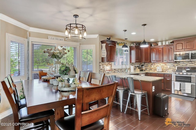 2548 S Gallop Cir, Wasilla, AK 99654 - dining room with plenty of natural light, a chandelier, crown molding, dark wood-style floors, and recessed lighting