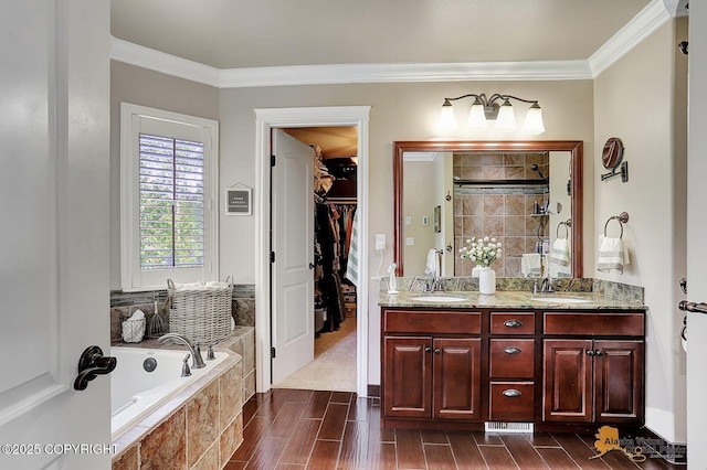 2548 S Gallop Cir, Wasilla, AK 99654 - bathroom featuring a bath, a stall shower, ornamental molding, a spacious closet, and double vanity