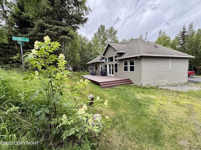14740 Maxwell Pl, Anchorage, AK 99516 - rear view of house featuring a deck, a lawn, and roof with shingles