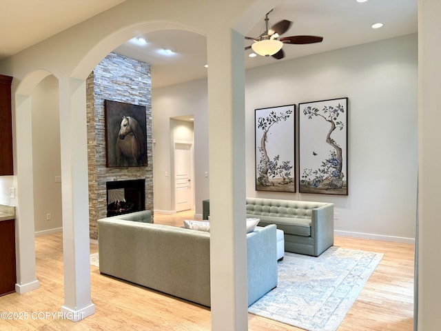 14740 Maxwell Pl, Anchorage, AK 99516 - living room featuring ceiling fan, light wood-style floors, a stone fireplace, recessed lighting, and baseboards