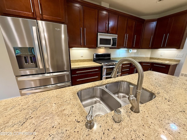 14740 Maxwell Pl, Anchorage, AK 99516 - kitchen featuring appliances with stainless steel finishes, a sink, and light stone counters