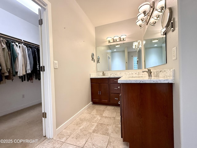 14740 Maxwell Pl, Anchorage, AK 99516 - bathroom with double vanity, baseboards, and a walk in closet