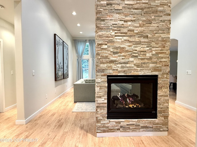 14740 Maxwell Pl, Anchorage, AK 99516 - unfurnished living room with wood finished floors, baseboards, a multi sided fireplace, and recessed lighting