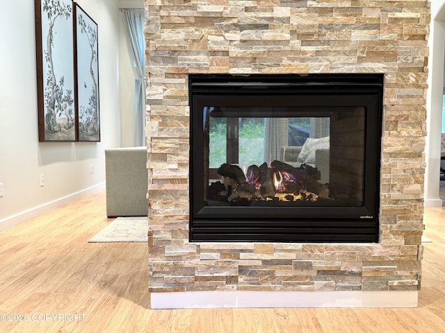 14740 Maxwell Pl, Anchorage, AK 99516 - detailed view of a fireplace, wood finished floors, and baseboards