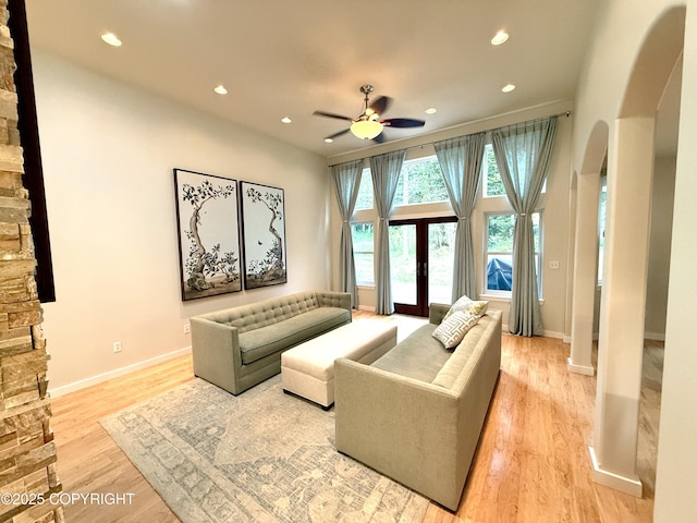 14740 Maxwell Pl, Anchorage, AK 99516 - living room featuring arched walkways, ceiling fan, recessed lighting, light wood finished floors, and baseboards