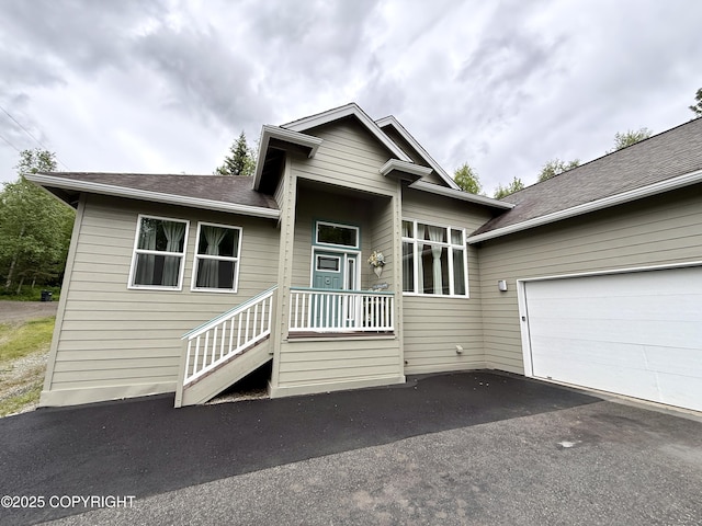 14740 Maxwell Pl, Anchorage, AK 99516 - view of front facade with asphalt driveway, an attached garage, and roof with shingles