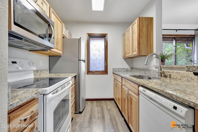 4221 Folker St # F203, Anchorage, AK 99508 - kitchen featuring white appliances, light wood-type flooring, light brown cabinets, and light stone counters