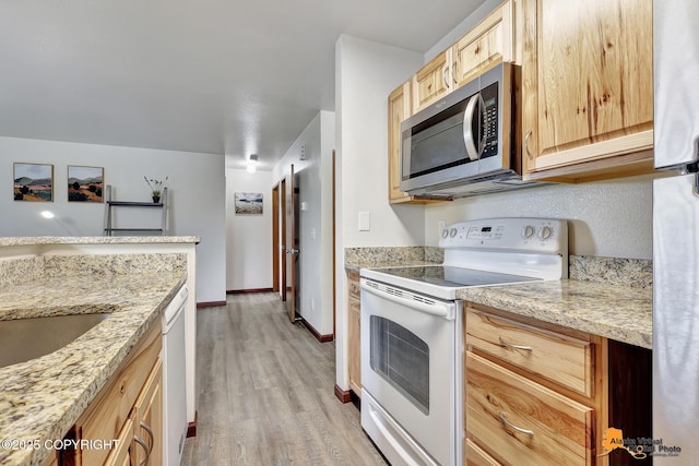 4221 Folker St # F203, Anchorage, AK 99508 - kitchen with white appliances, light brown cabinets, light wood finished floors, and light stone counters