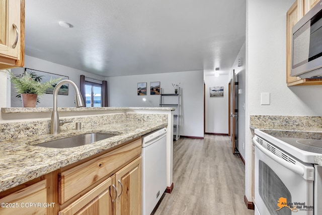 4221 Folker St # F203, Anchorage, AK 99508 - kitchen featuring white appliances, light wood-type flooring, light stone countertops, and light brown cabinets