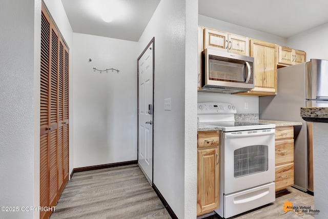 4221 Folker St # F203, Anchorage, AK 99508 - kitchen with appliances with stainless steel finishes, light brown cabinetry, light wood finished floors, and light countertops