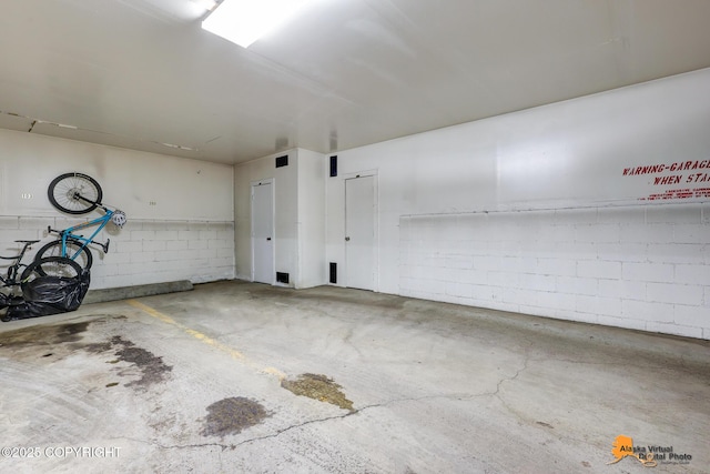 4221 Folker St # F203, Anchorage, AK 99508 - parking deck featuring concrete block wall