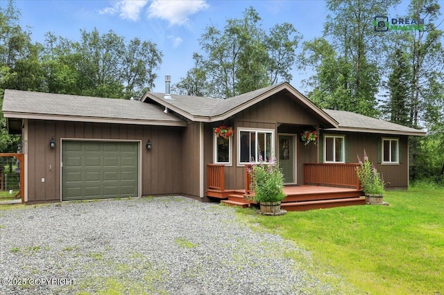 8520 E Gold Bullion Blvd, Palmer, AK 99645 - view of front of house with an attached garage, gravel driveway, and a front lawn