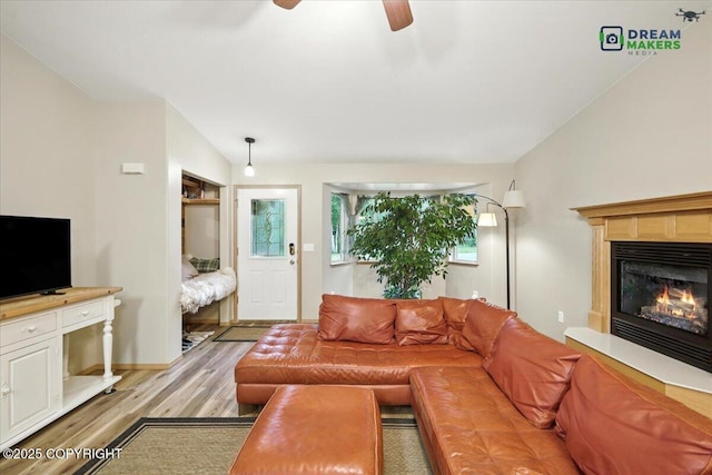 8520 E Gold Bullion Blvd, Palmer, AK 99645 - living room featuring light wood finished floors, ceiling fan, a glass covered fireplace, and lofted ceiling