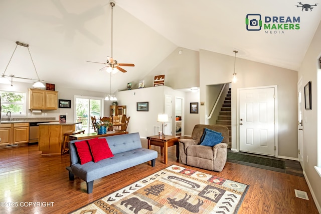 3111 N Intuition Dr, Wasilla, AK 99654 - living room with dark wood finished floors, stairs, high vaulted ceiling, and ceiling fan