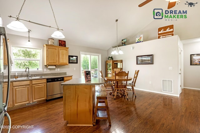 3111 N Intuition Dr, Wasilla, AK 99654 - kitchen featuring stainless steel dishwasher, a kitchen breakfast bar, ceiling fan, a kitchen island, and dark wood-type flooring