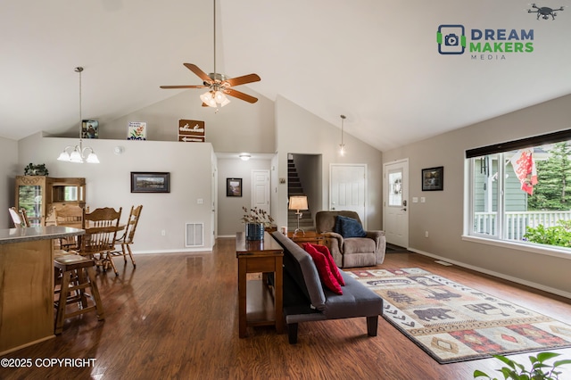 3111 N Intuition Dr, Wasilla, AK 99654 - living area with high vaulted ceiling, dark wood-style floors, ceiling fan, a chandelier, and stairway