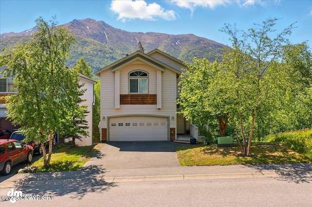 9198 Eagle River Ln, Eagle River, AK 99577 - view of front of home with an attached garage, a mountain view, and asphalt driveway