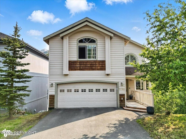 9198 Eagle River Ln, Eagle River, AK 99577 - traditional home with asphalt driveway and an attached garage