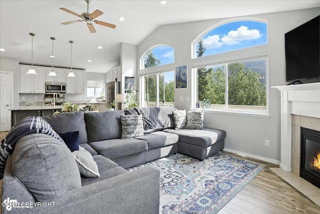 9198 Eagle River Ln, Eagle River, AK 99577 - living room featuring ceiling fan, a tile fireplace, recessed lighting, light wood finished floors, and lofted ceiling