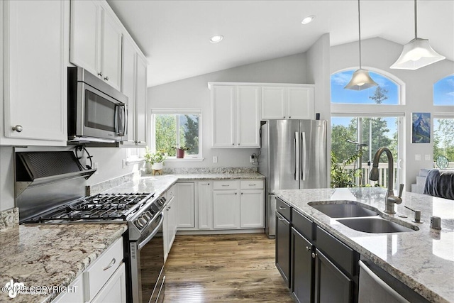9198 Eagle River Ln, Eagle River, AK 99577 - kitchen featuring stainless steel appliances, white cabinets, pendant lighting, light stone counters, and recessed lighting