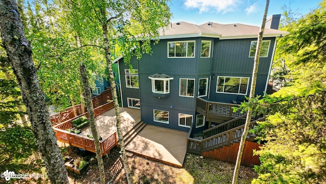 17001 Yellowstone Dr, Eagle River, AK 99577 - rear view of house featuring a wooden deck, a chimney, and stairway