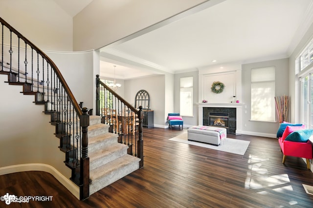 17001 Yellowstone Dr, Eagle River, AK 99577 - staircase with a chandelier, wood finished floors, a fireplace, and ornamental molding