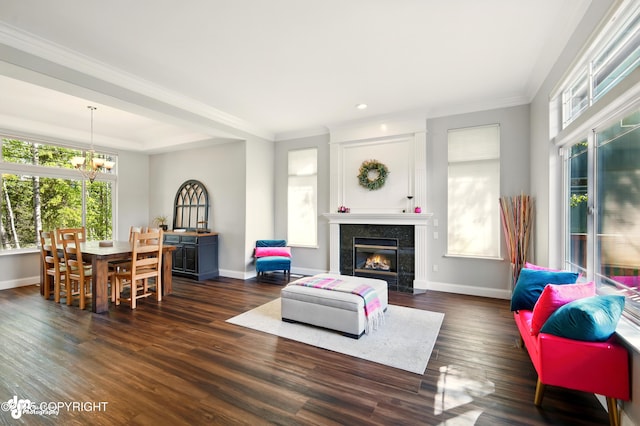 17001 Yellowstone Dr, Eagle River, AK 99577 - living area featuring a chandelier, plenty of natural light, a fireplace, dark wood-style floors, and ornamental molding