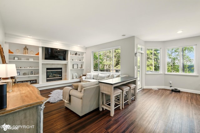 17001 Yellowstone Dr, Eagle River, AK 99577 - living room featuring dark wood-style flooring, a tiled fireplace, and recessed lighting