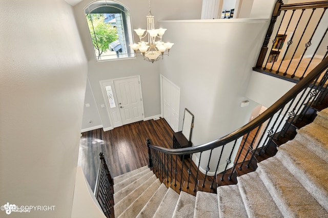 17001 Yellowstone Dr, Eagle River, AK 99577 - entrance foyer featuring healthy amount of natural light, stairway, a chandelier, a high ceiling, and wood finished floors