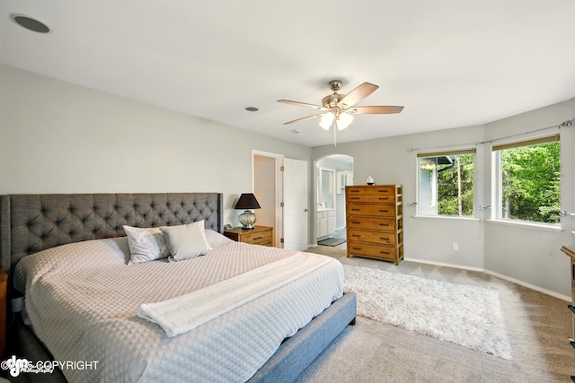 17001 Yellowstone Dr, Eagle River, AK 99577 - bedroom featuring arched walkways, carpet flooring, ceiling fan, and connected bathroom