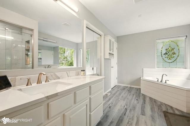 17001 Yellowstone Dr, Eagle River, AK 99577 - full bath featuring vanity, a bath, a shower stall, and wood finished floors