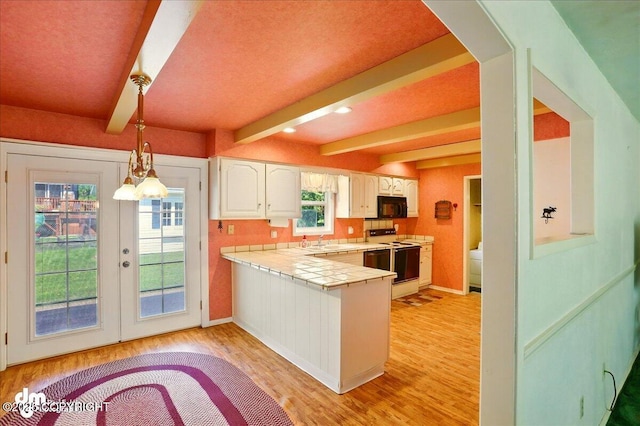 19807 First St, Eagle River, AK 99577 - kitchen featuring white electric range oven, black microwave, tile counters, a peninsula, and light wood-style floors