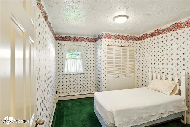 19807 First St, Eagle River, AK 99577 - bedroom with baseboard heating, carpet floors, a closet, a textured ceiling, and wallpapered walls