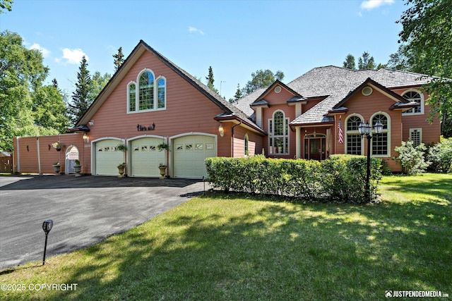 2215 S Austin Cir, Palmer, AK 99645 - traditional-style house with asphalt driveway, an attached garage, and a front lawn