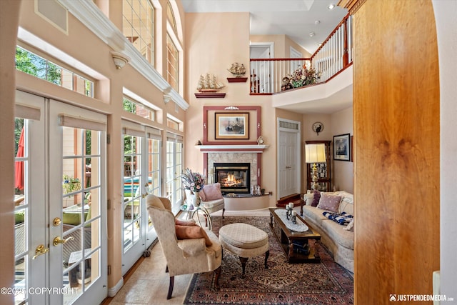 2215 S Austin Cir, Palmer, AK 99645 - living area featuring french doors, a high ceiling, healthy amount of natural light, and a tile fireplace